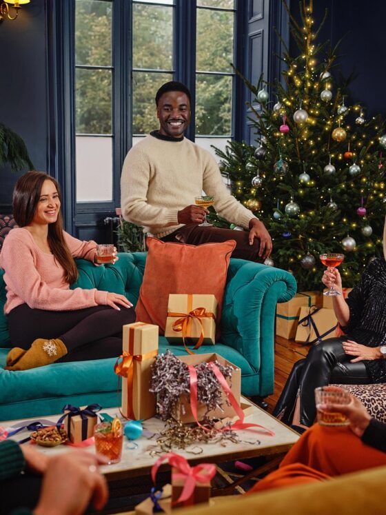 Women and men at holiday party, giving presents, cocktails, Christmas, beauty routine, holidays