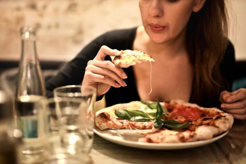 Woman eating pizza