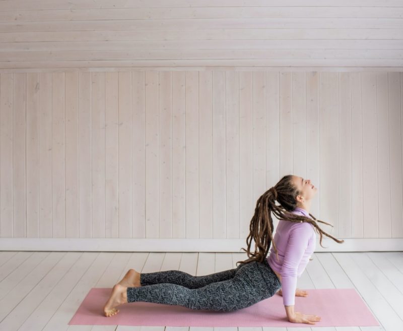 Yoga Classes: Woman posing near window