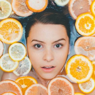 Vitamin C Serum: Woman in Spa Surrounded by Citrus