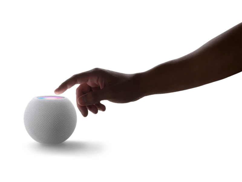 HomePod Mini: Hand reaching out toward unit