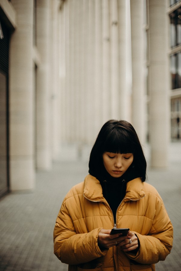 Improve Your Posture: Woman walking and texting