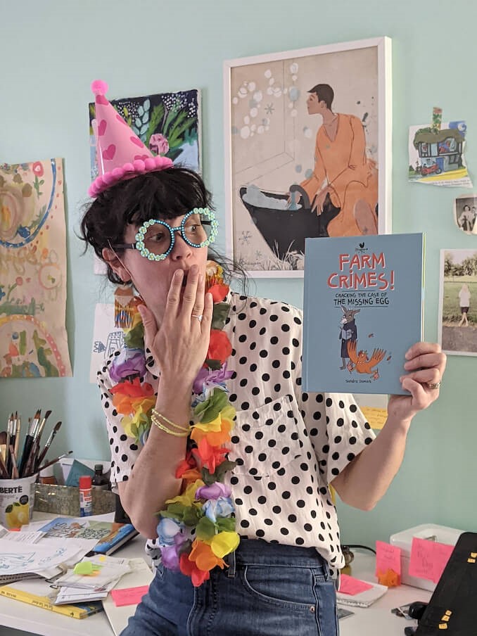 Montréal's Arts and Culture: Sandra Dumais holding up kids' book