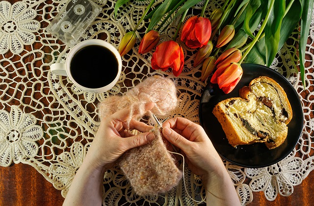 Balancing Work: Knitting with coffee cup and danish