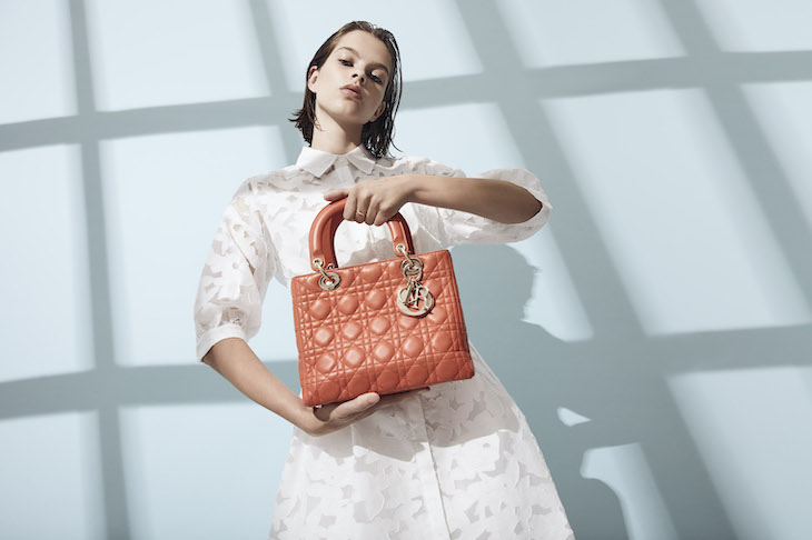 Preloved Luxury Items: Woman holding a Lady Dior Bag