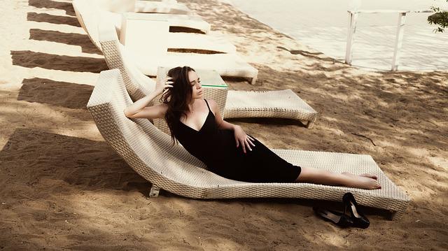 Wardrobe Staples: Woman on a lounger in a black dress