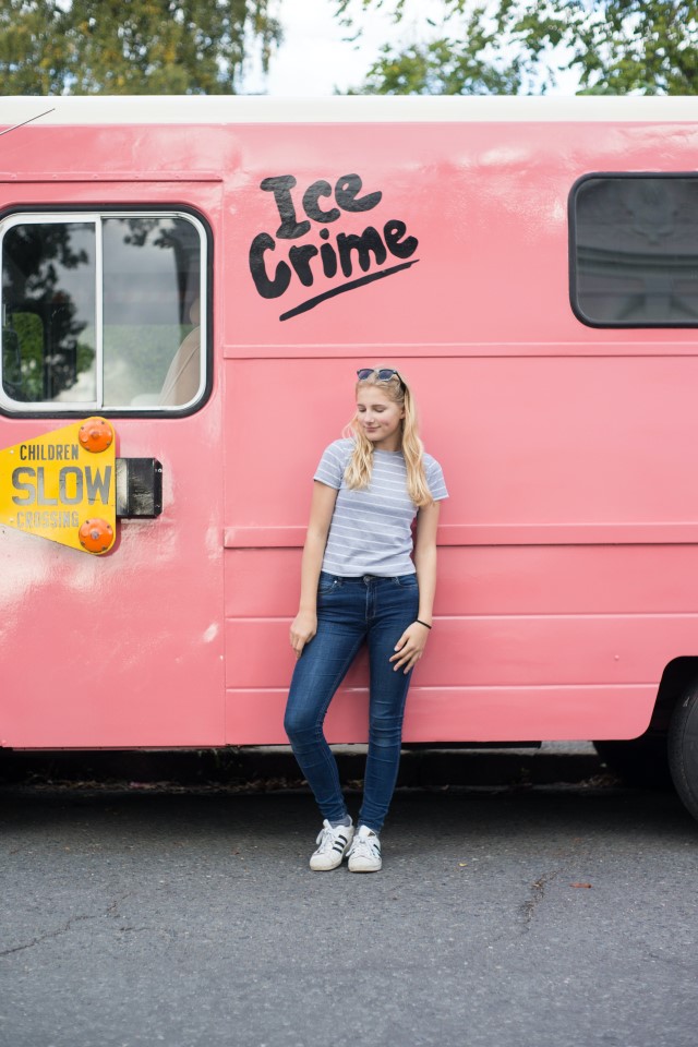 Woman in a t-shirt standing by a truck