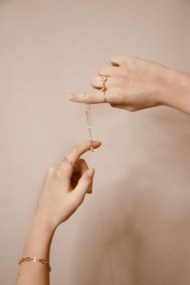 Finding the right jewelry: A set of hands holding a bracelet