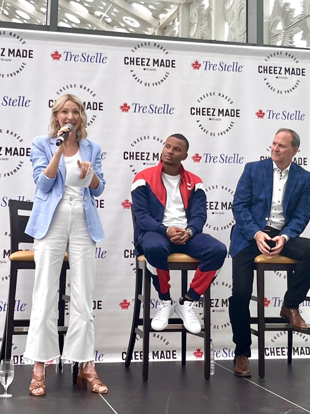 Abbey Sharpe speaking with Andre De Grasse and Arla Foods CEO looking on