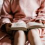 Help your child to read: Child with book in her lap