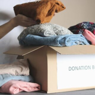 Your Clothes: Girl puts donations in a box with items