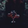 Best Halloween Items: Woman in Witches Costume holding a wine goblet