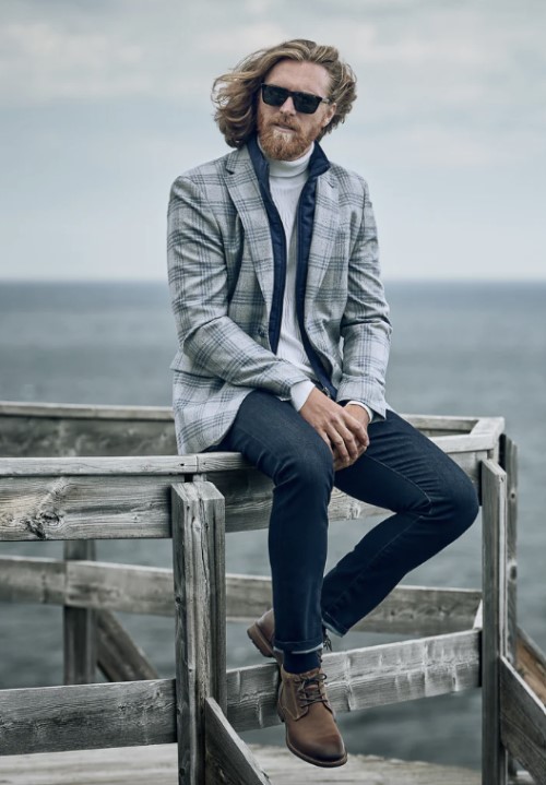 Sport Jacket: Man sitting on pier near ocean