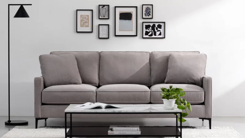 Noa Home: Sofa, coffee table, geometric lamp with abstract paintings behind the sofa