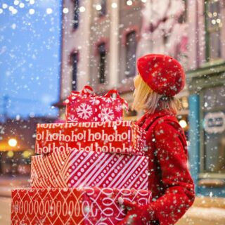 Festive Season: Woman walking with holiday gifts