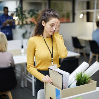 Layoff: Woman packing up her desk