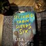 Secluded Cabin Sleeps Six: Book on a table in dim light