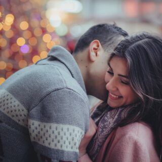 Married Couples: Couple embracing near Christmas Tree