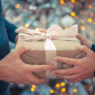 Best Gift Ideas: Man receiving a gift from a woman
