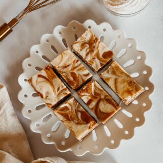 Cheesecake Bars: Pumpkin Cheesecake Bars plated with whisk