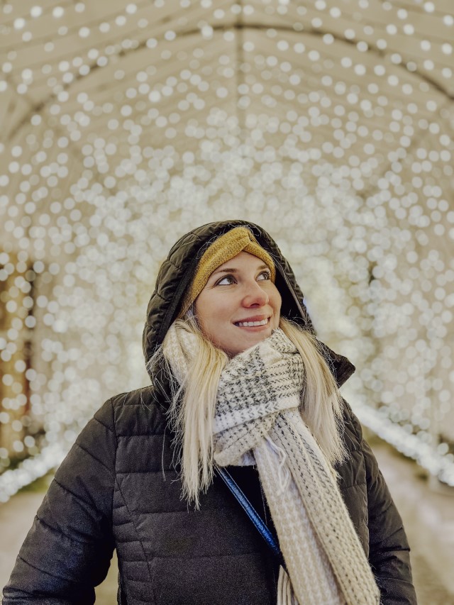 Holiday Photos: Woman in a winter jacket in a tunnel of lights