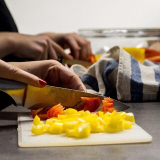 Perfect Gift for a Chef: Woman cutting fruit on a cutting board