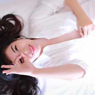 Spring Hair Care: woman lying on bed with her hair fanned out