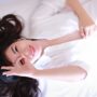 Spring Hair Care: woman lying on bed with her hair fanned out