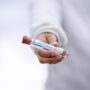 Level of Antibodies: Man holding test tube