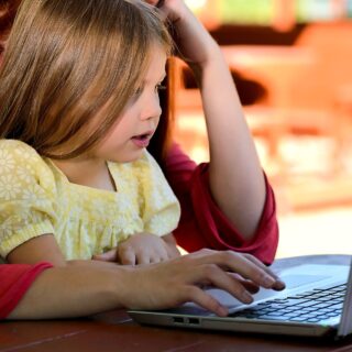 Best Coding Gifts: Little girl and Mom in front of laptop