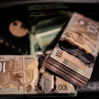 Supplement your income: Canadian $100 bills in two stacks