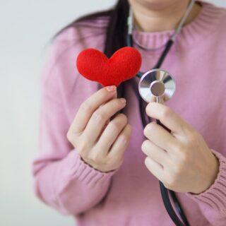 Health Check Ups: Doctor holding stuffed Heart