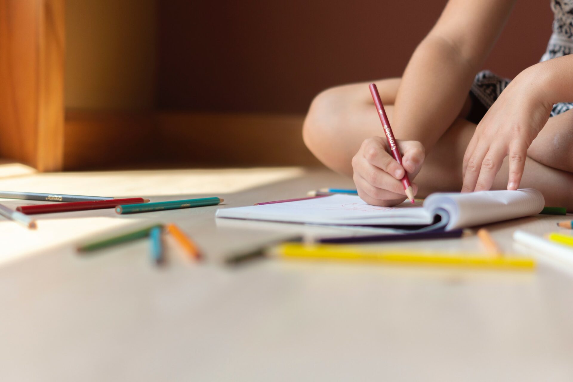 Early Childhood Stimulation: Child colouring with colour pencils