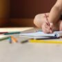Early Childhood Stimulation: Child colouring with colour pencils