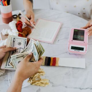 Investment: Couple at a table with a calculator counting money