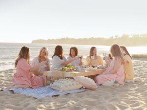 Jillian Harris: Jillian Harris sitting around a low table at the beach with 6 women