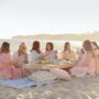 Jillian Harris: Jillian Harris sitting around a low table at the beach with 6 women