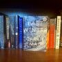 Last Winter: Last Winter on a book shelf with other books spines forward