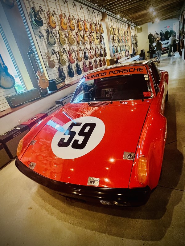 WallGrace Vintage Cars & Guitars - Porche with wall of guitars in the background