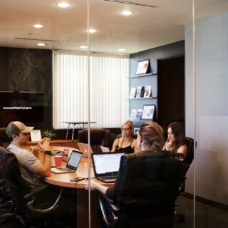Hiring the best employees: employees sitting around a conference table in a meeting