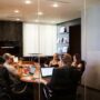 Hiring the best employees: employees sitting around a conference table in a meeting