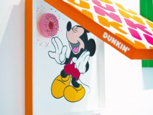Sprinkles: A Sweet Body of Work: Mickey Mouse reaching for a donut under a Dunkin' Donuts Box