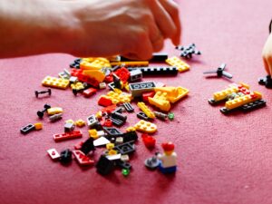 LEGO Sets: An adult hand and child hand picking up LEGO