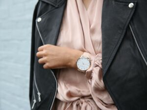 Fashion Sense: Woman wearing peach dress with black motorcycle jacket with close up of watch