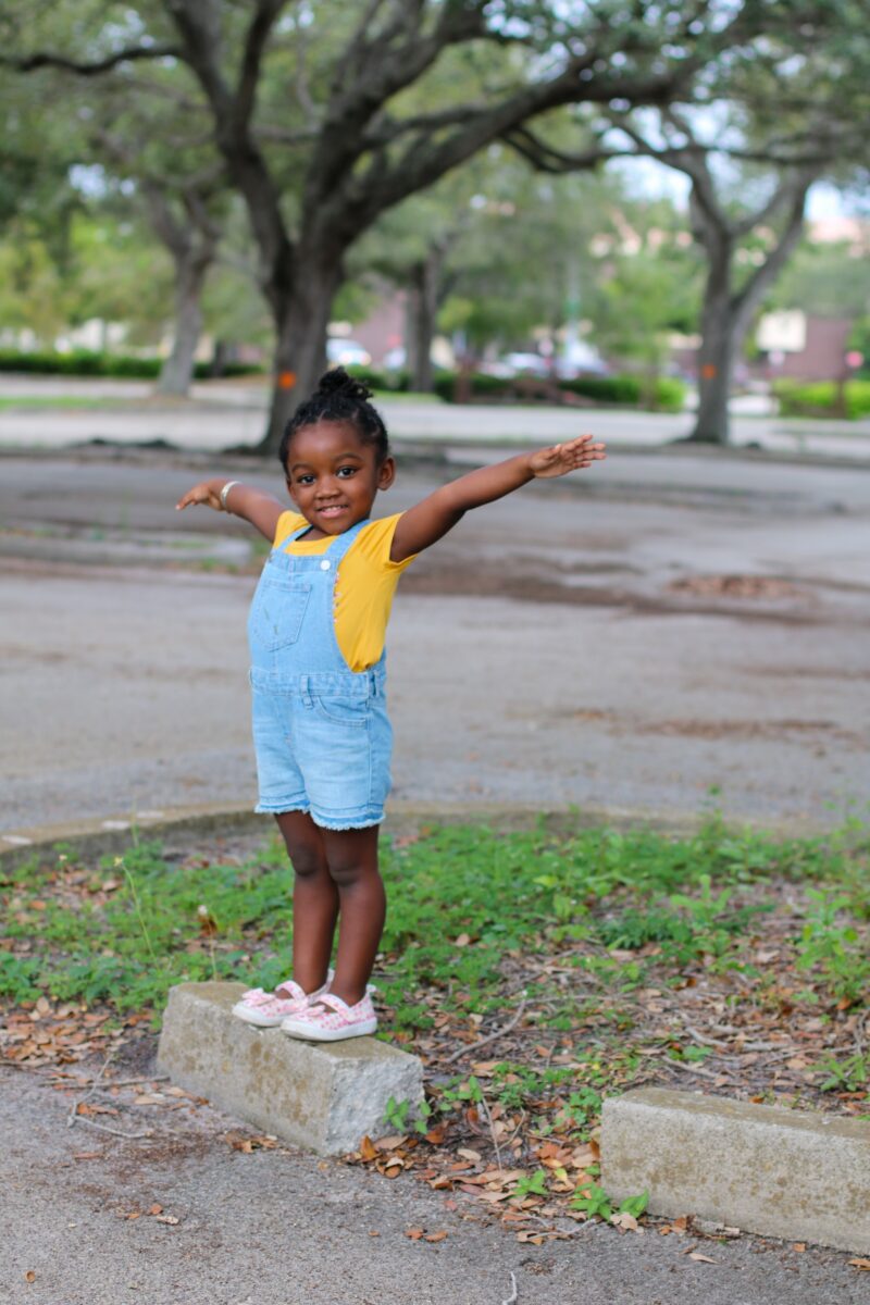 Potty Training: Young black girl smiling as she spreads her arms outside