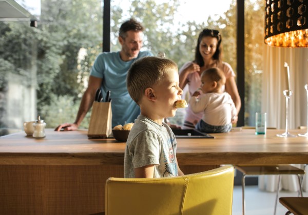 Kid in kitchen with family