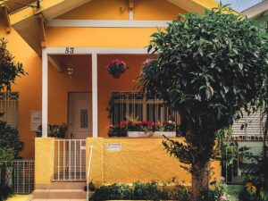 Curb Appeal: Exterior of a Home with Yellow Pain and a tree