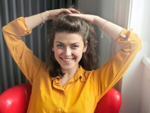 Intentional Life: Woman holding her hair back in a yellow blouse