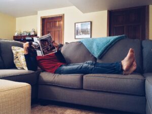 Vacation Days: Person relaxing on a sofa with a magazine