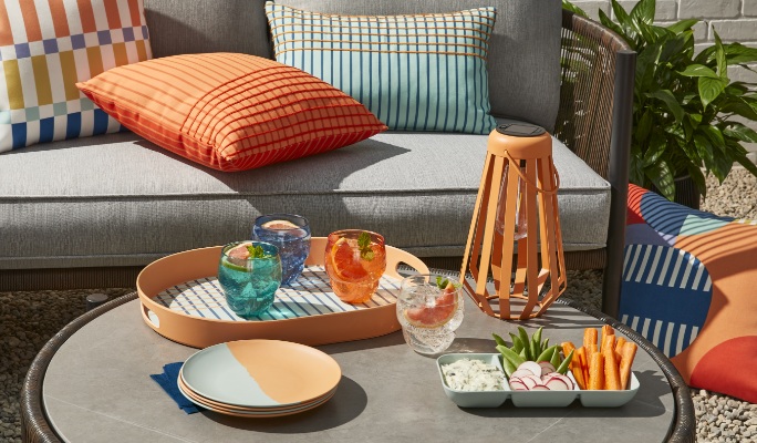 Patio Furniture: Close up of outdoor accessories including glassware, cushions and a lantern